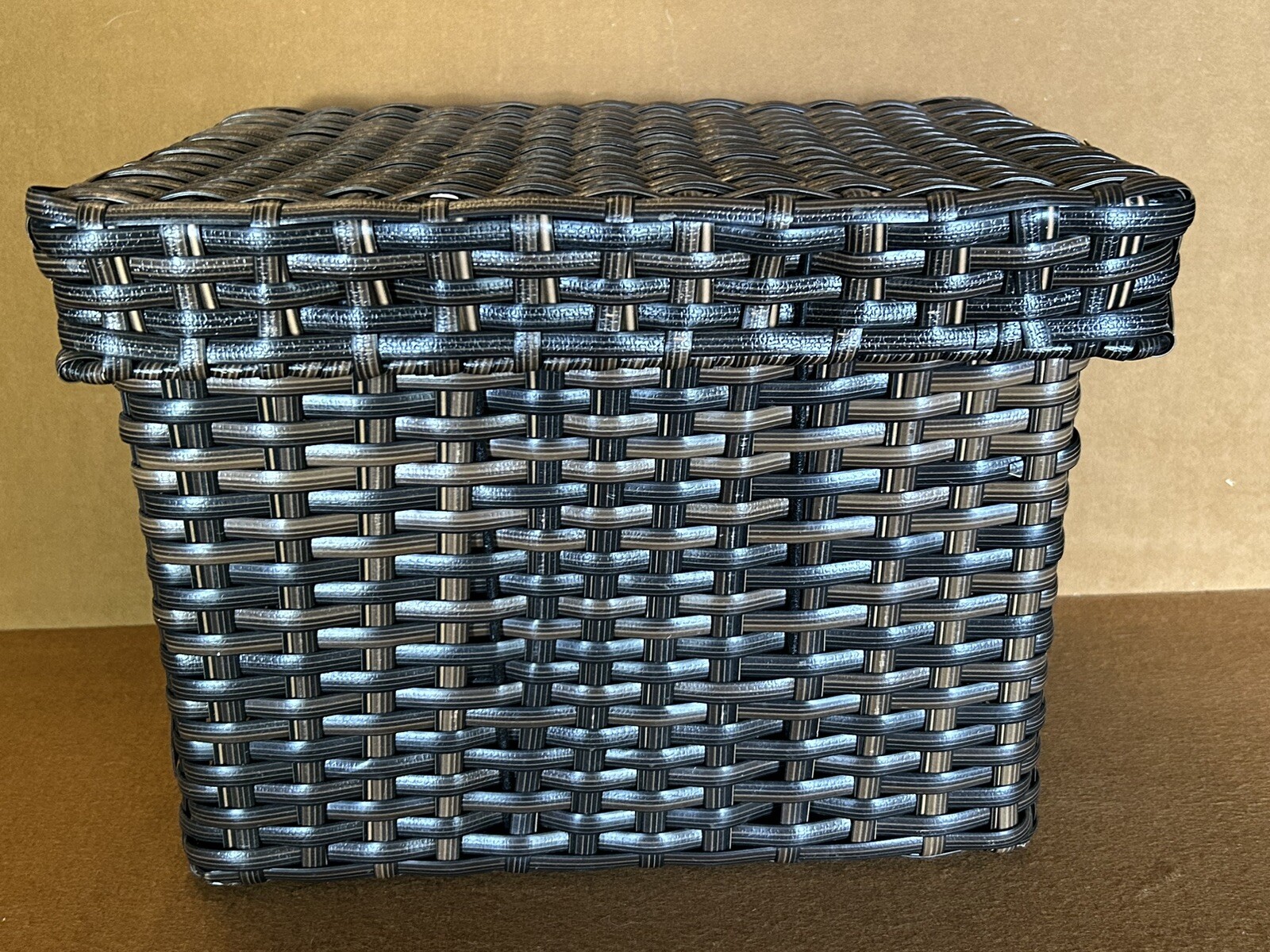Large wicker weaved storage basket metal bar structure inside lift off lid brown