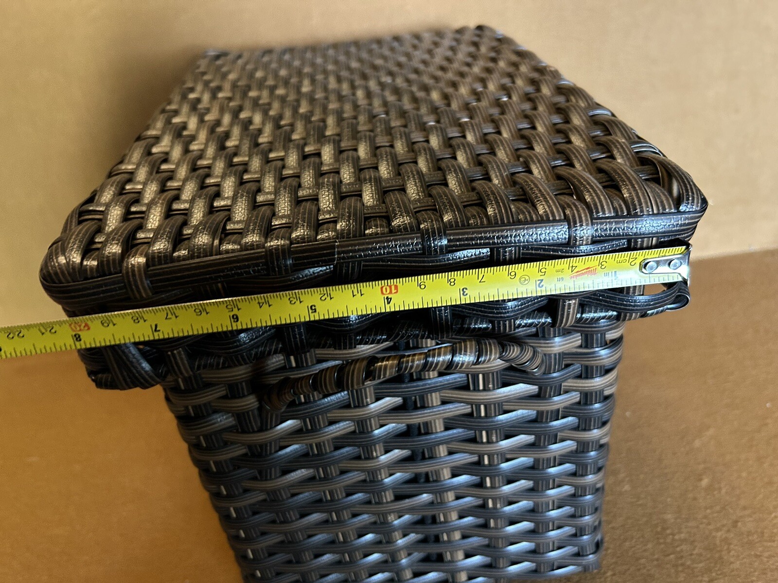 Large wicker weaved storage basket metal bar structure inside lift off lid brown