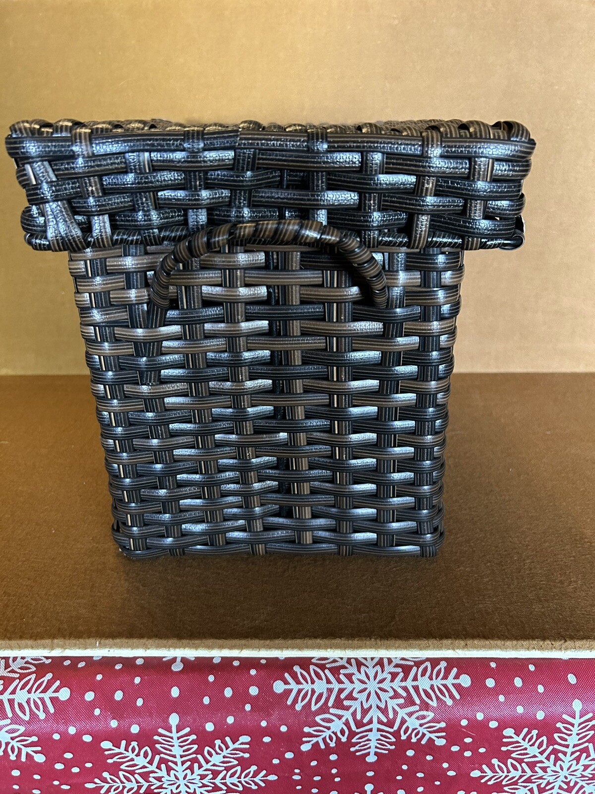 Large wicker weaved storage basket metal bar structure inside lift off lid brown