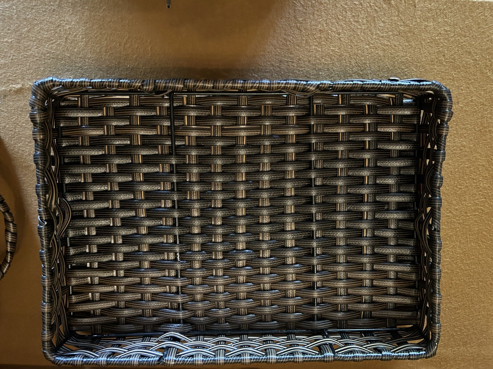 Large wicker weaved storage basket metal bar structure inside lift off lid brown