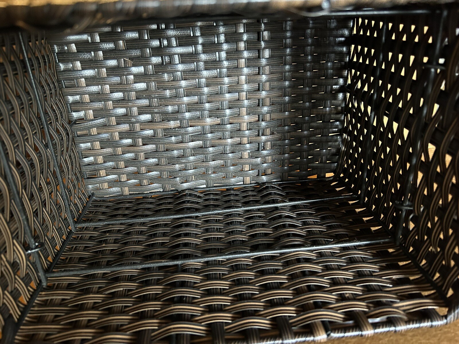Large wicker weaved storage basket metal bar structure inside lift off lid brown