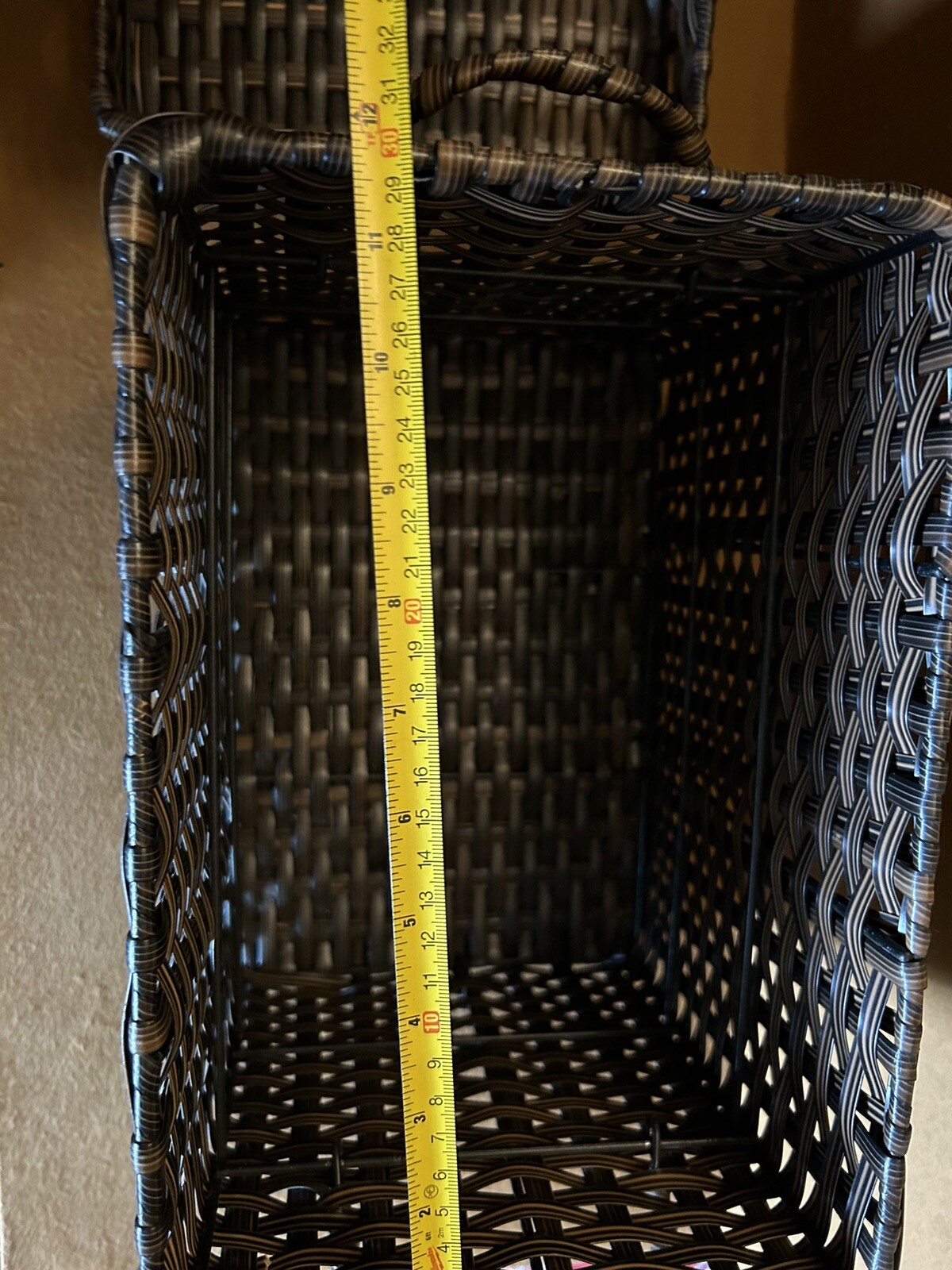 Large wicker weaved storage basket metal bar structure inside lift off lid brown