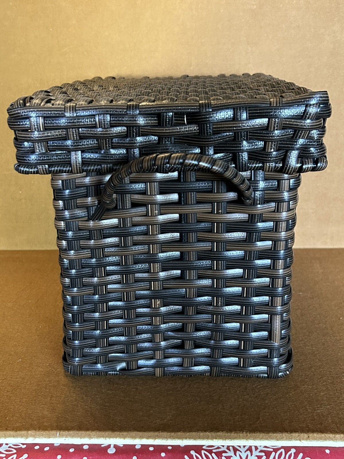 Large wicker weaved storage basket metal bar structure inside lift off lid brown