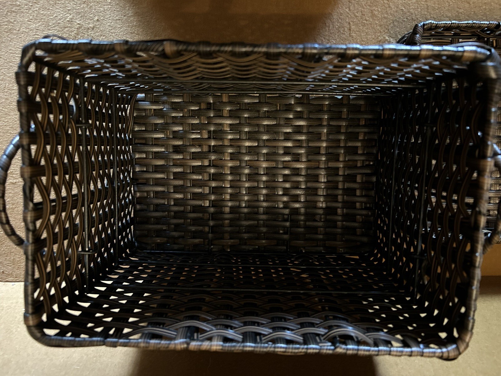 Large wicker weaved storage basket metal bar structure inside lift off lid brown