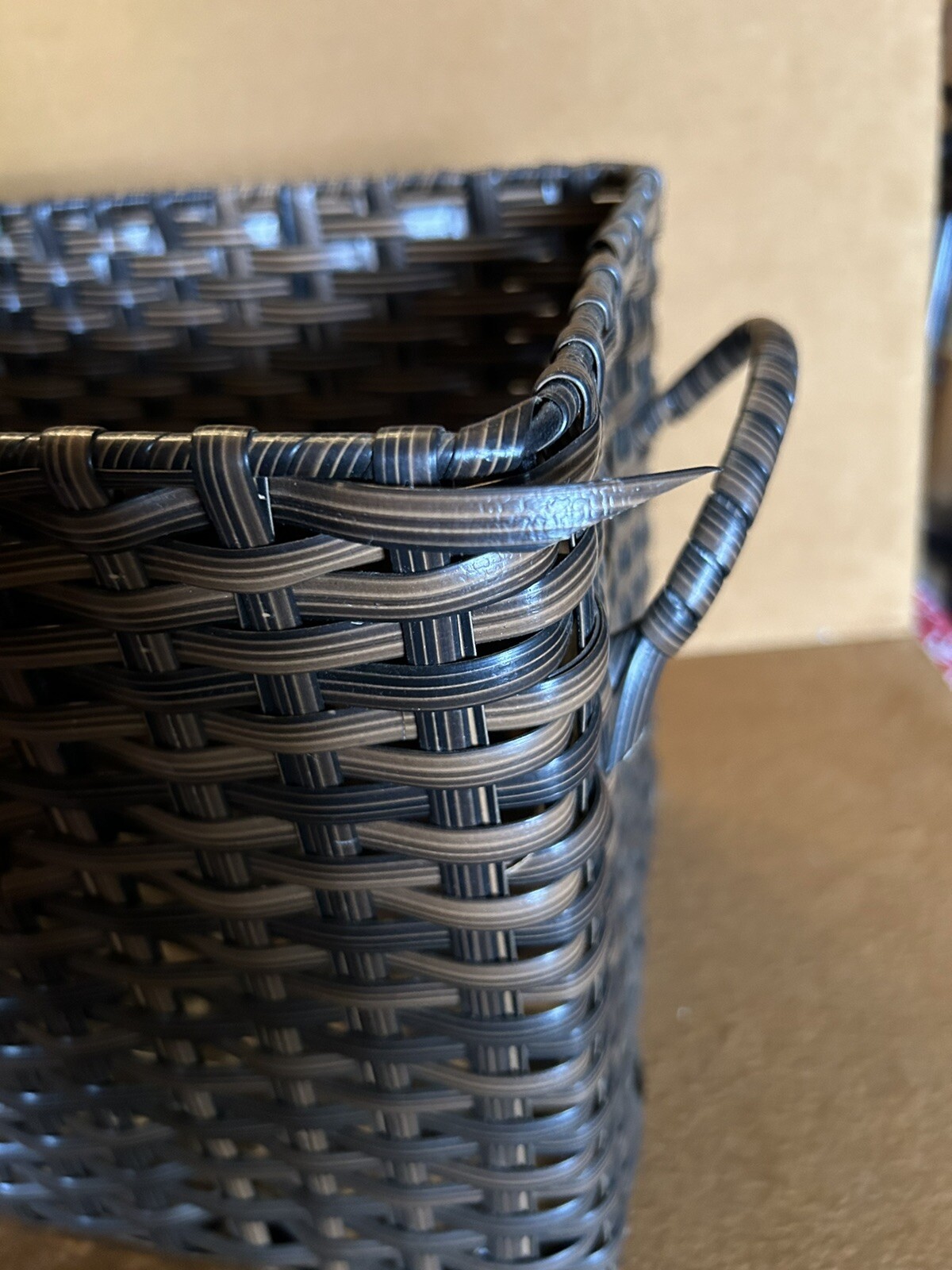 Large wicker weaved storage basket metal bar structure inside lift off lid brown