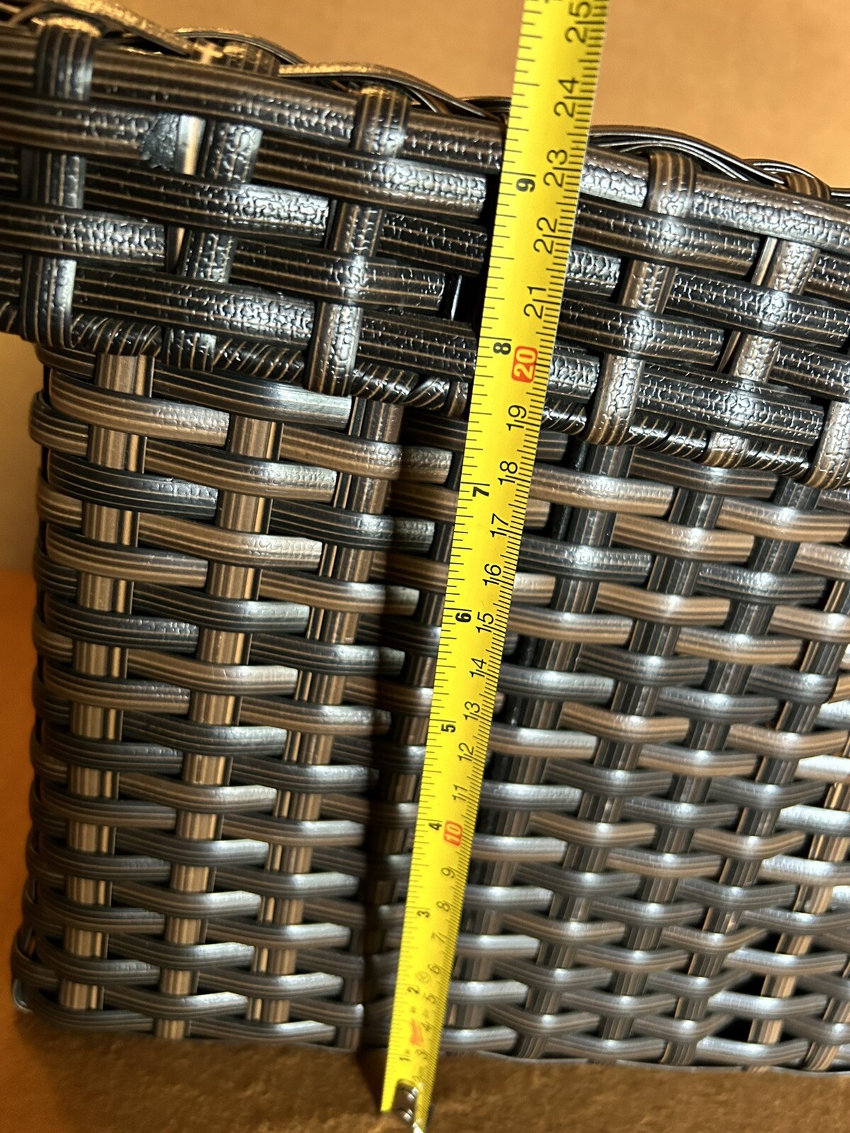 Large wicker weaved storage basket metal bar structure inside lift off lid brown